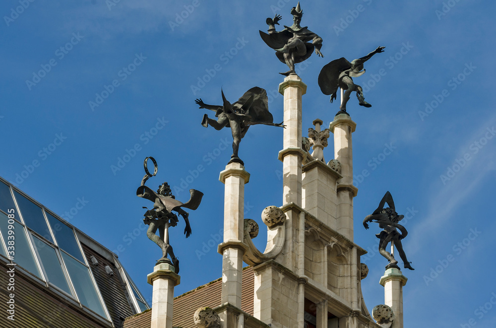 Ghent, Flemish Region / Belgium - april 24 2012 : On top of the stepped gable of theMasons’ Guild Hall. six dancers turn merrily with the wind in Ghent, Belgium