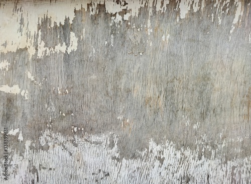 texture of wooden plywood with peeling old white paint