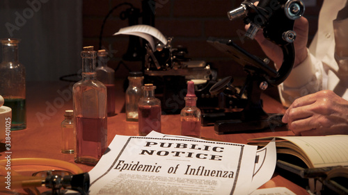 Notice of the influenza epidemic of the year 1918 lying on the laboratory table of a medical research scientist studying the virus.