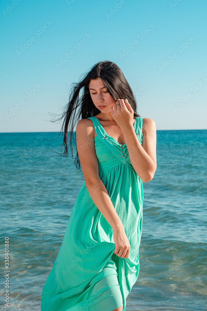 Beautiful woman on the beach. Single girl in long dress. Beautiful woman on the beach. Single girl in long dress.