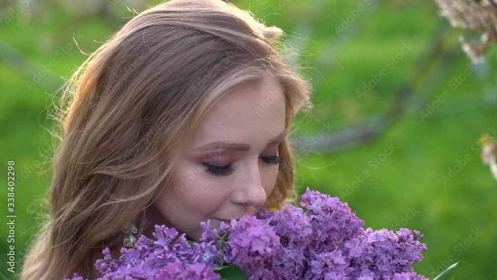 Pretty girl portrait near blossomed tree in park. Concept of youth and natural beauty. Girl smells scent of cherry blossoms in spring in the garden. Woman and spring nature, natural cosmetics Pretty girl portrait near blossomed tree in park. Concept of youth and natural beauty. Girl smells scent of cherry blossoms in spring in the garden. Woman and spring nature, natural cosmetics
