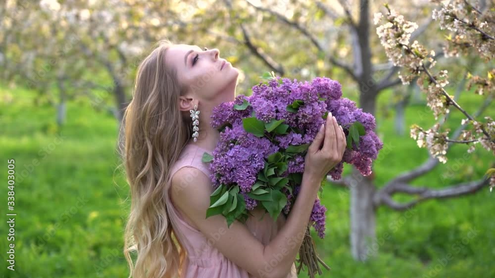 Pretty girl portrait near blossomed tree in park. Concept of youth and natural beauty. Girl smells scent of cherry blossoms in spring in the garden. Woman and spring nature, natural cosmetics Pretty girl portrait near blossomed tree in park. Concept of youth and natural beauty. Girl smells scent of cherry blossoms in spring in the garden. Woman and spring nature, natural cosmetics