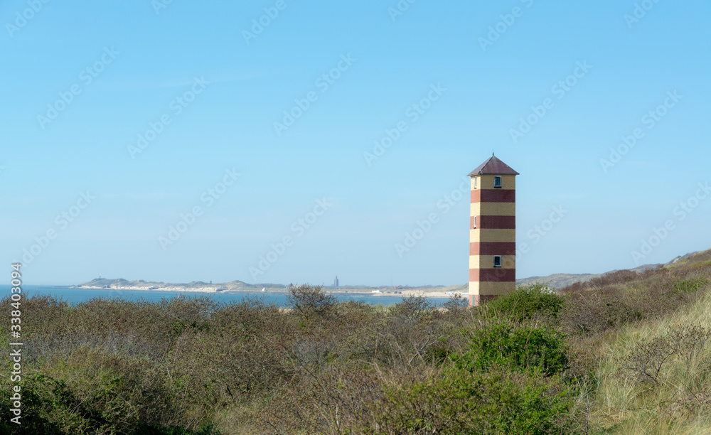 Lighthouse on the coast in Dishoek Zeeland in the Netherlands with blue sky
