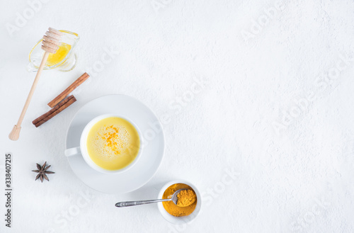 Top view image of turmeric latte over white table with copy space. Golden milk
