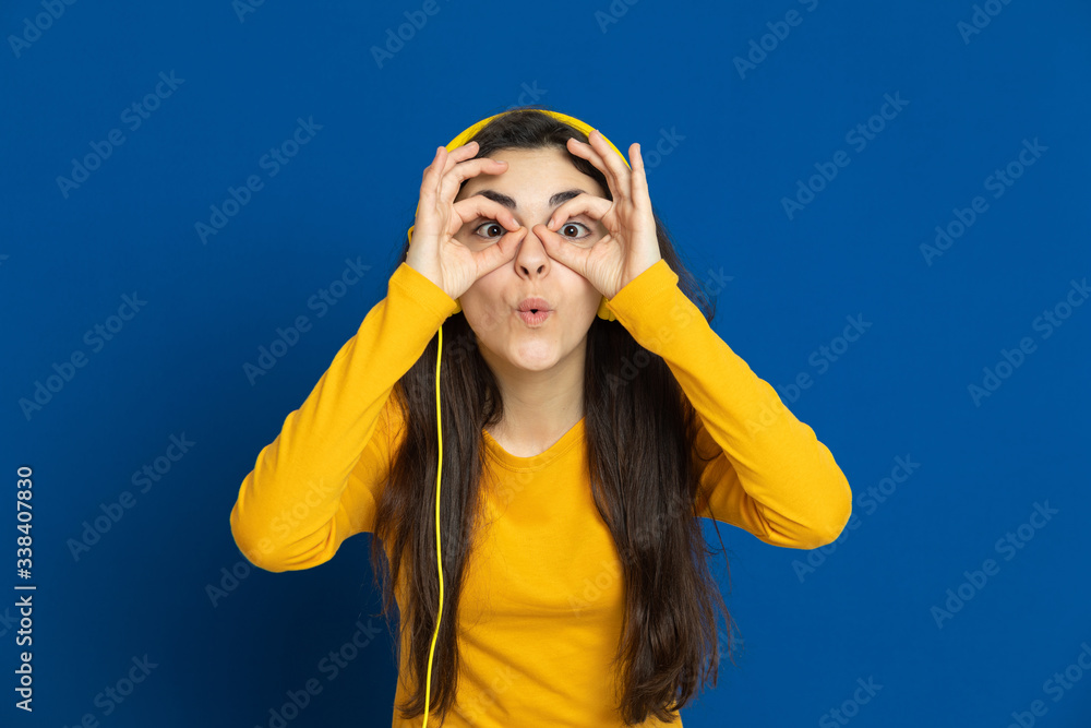 Brunette young girl wearing yellow jersey Brunette young girl wearing yellow jersey