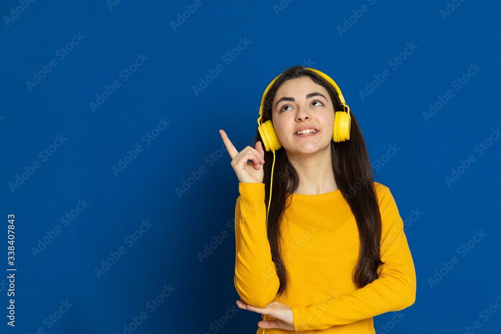 Brunette young girl wearing yellow jersey Brunette young girl wearing yellow jersey