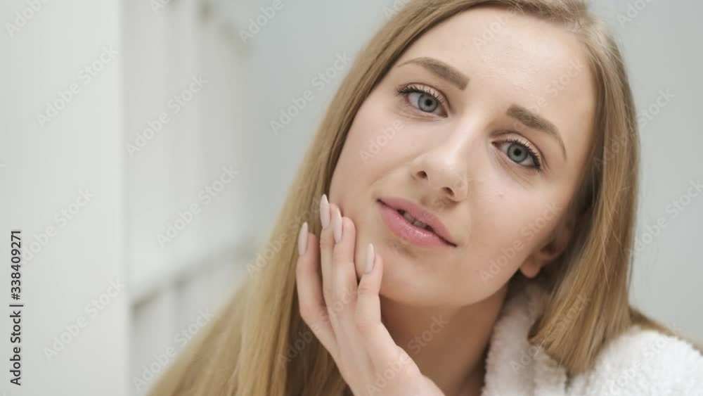 Portrait of cute woman with well-groomed skin posing at camera in bright room Portrait of cute woman with well-groomed skin posing at camera in bright room