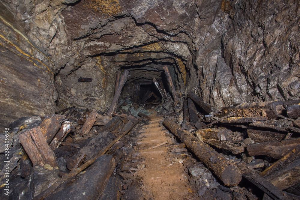 Underground abandoned bauxite ore mine tunnel with collapsed wooden timbering
Underground abandoned bauxite ore mine tunnel with collapsed wooden timbering