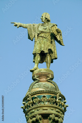 Statue of Christopher Columbus points west to New World, next to waterfront of Port Vell, Barcelona, Spain