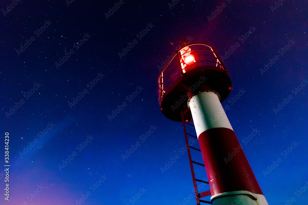 red lighthouse on the background of stars red lighthouse on the background of stars