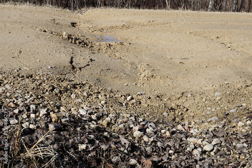 Gravel road, frost heave and dip at center line culvert
