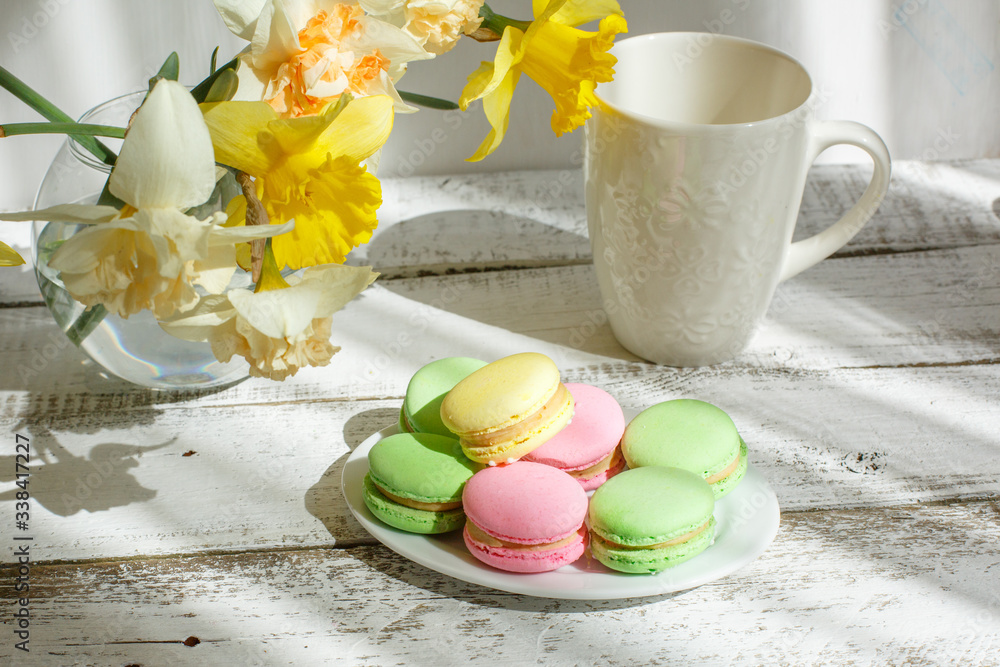 a Cup of tea with macaroons morning Breakfast with a bouquet of flowers in a vase a Cup of tea with macaroons morning Breakfast with a bouquet of flowers in a vase