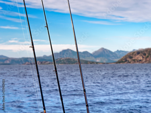 Fishing rods against Norwegian Sea. © nupsik284