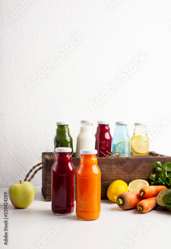 Healthy smoothie in glass bottles and fresh vegetables