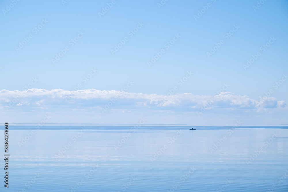 Blue lake with straight horizon and boat Blue lake with straight horizon and boat