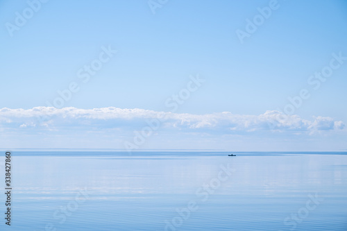 Blue lake with straight horizon and boat