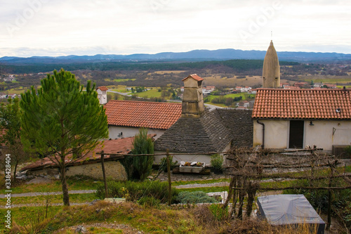 The old historic hill village of Stanjel in the Komen municipality of Primorska, south west Slovenia. The distinctive lemon shaped tower of the church of St Daniel can be seen
 photo