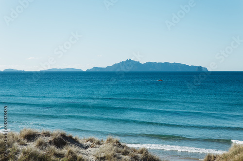 Beach view on an island with blue water and blue sky