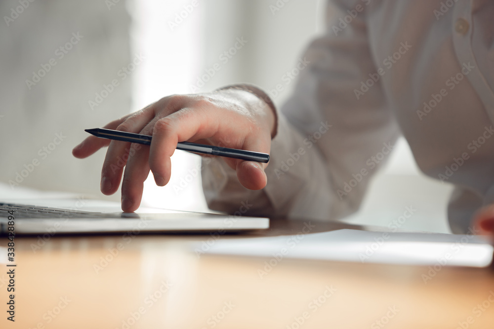 Close up. Caucasian young man in business attire working in office. Young businesswoman, manager doing tasks with smartphone, laptop, tablet has online conference, studying. Concept of job, education. Close up. Caucasian young man in business attire working in office. Young businesswoman, manager doing tasks with smartphone, laptop, tablet has online conference, studying. Concept of job, education.