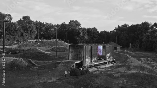 Black and White selectively colorized cinemagraphic of rail card on dirt bike park trail photo