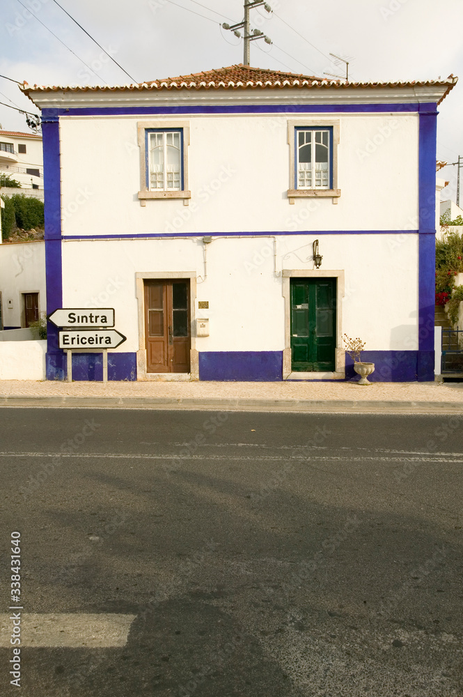 House and street sign points to Sintra and Ericeira, Portugal