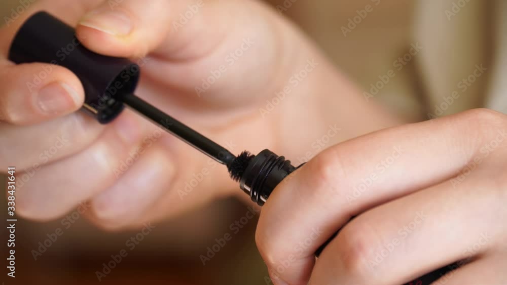 hands are opening new mascara for eyebrows hands are opening new mascara for eyebrows
