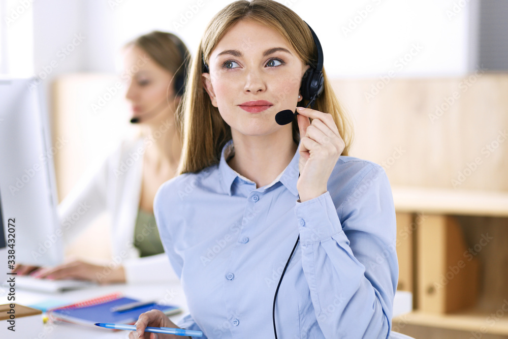 Portrait of call center operator at work. Group of people in a headset ready to help customers. Business concept Portrait of call center operator at work. Group of people in a headset ready to help customers. Business concept
