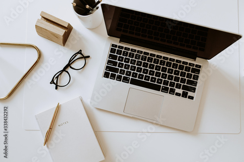 Slika na platnu Home office desk workspace with laptop, notebook, glasses on white table
