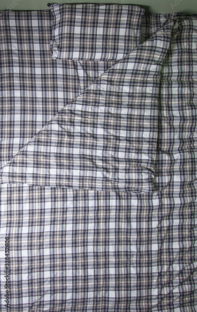 Checked bedding set - duvet cover, pillowcase and sheet. Isolated bed on white Checked bedding set - duvet cover, pillowcase and sheet. Isolated bed on white