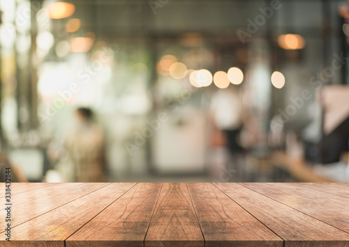 Wooden top table with bokeh light effect and blur restaurant on background, blur background