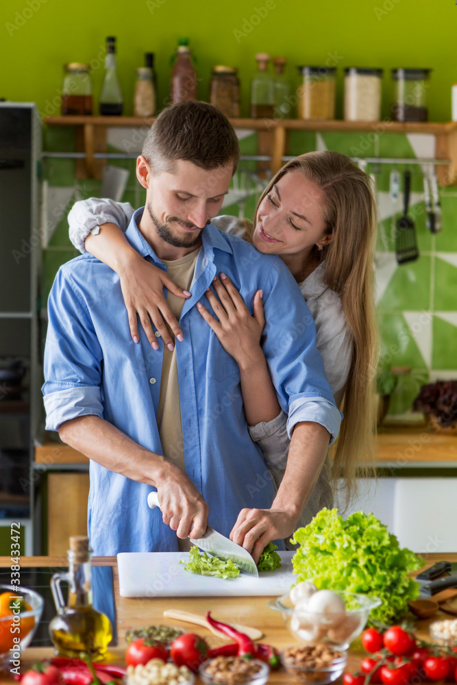 Happy couple preparing healthy vegetarian meal together