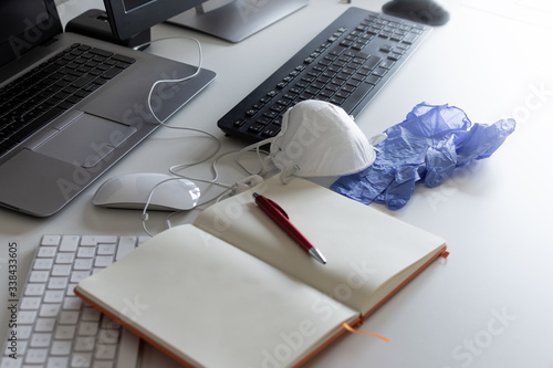 Medical mask and gloves on the desktop. Remote work and study. Notepad with place for text and pen for notes. Layout. Desktop, workspace for working at home