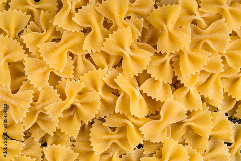 Top view closeup macro on italian raw uncooked farfalle pasta, horizontal format Top view closeup macro on italian raw uncooked farfalle pasta, horizontal format