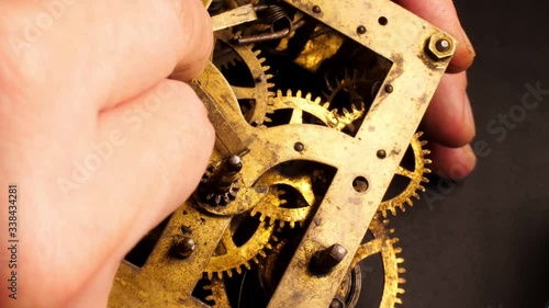 The watchmaker assembling the old clockwork. Brass watch wheels closeup.