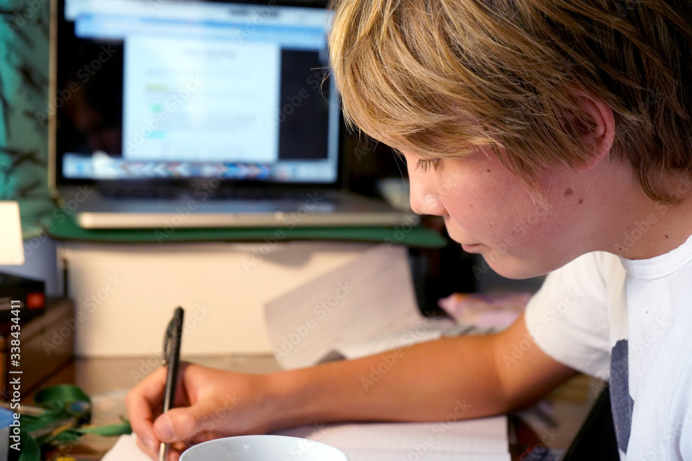 Young teenager doing schoolwork from home Young teenager doing schoolwork from home