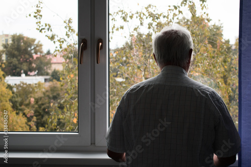 sad senior man stand alone stay at home inside closeup depressed coronavirus isolation