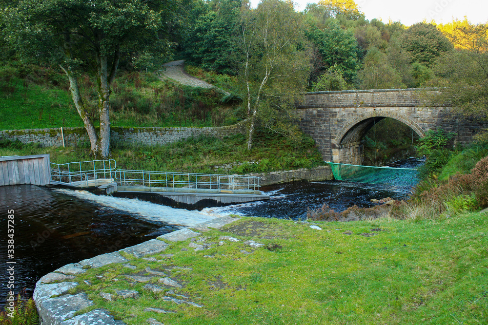 Naklejka premium River flowing down the weir at Langsett Reservoir