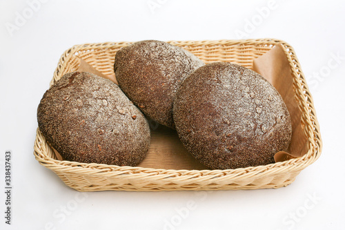 black bread with sunflower seeds in a basket white background