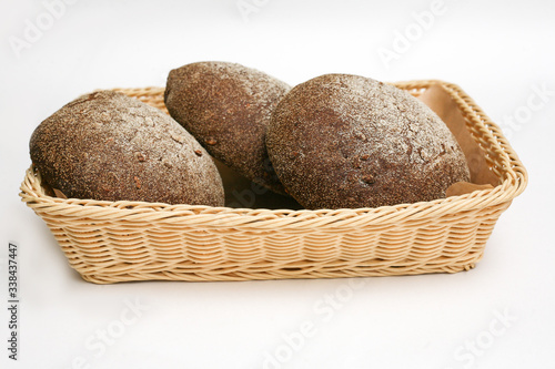 black bread with sunflower seeds in a basket white background