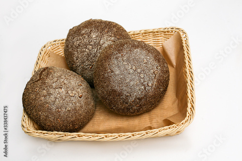 black bread with sunflower seeds in a basket white background