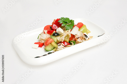 Greek salad on a plate white background