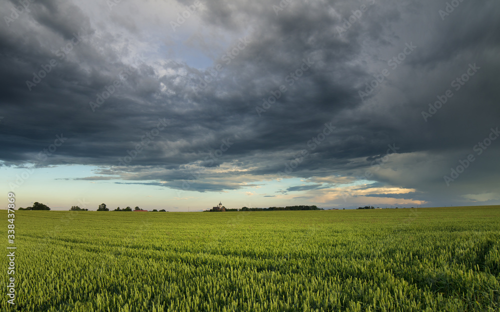 storm clouds over rural green spring fields storm clouds over rural green spring fields