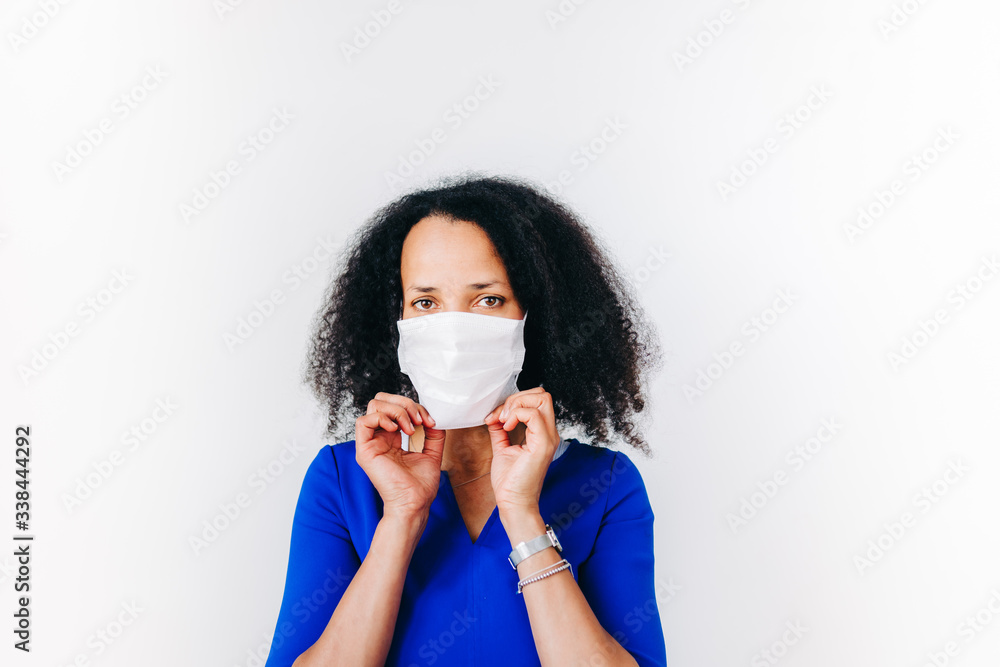 black woman putting on a surgical mask black woman putting on a surgical mask