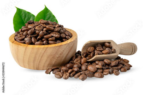 Coffee bean medium roasted in wooden bowl with leaf in fresh morning.