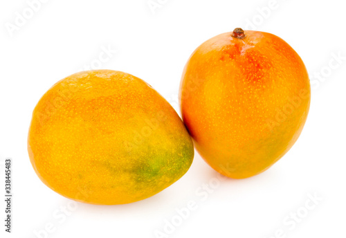 Fresh ripe mangoes close up isolated on white background