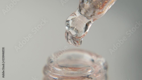 Drop of hydrating serum, oil, vitamin for face skin on white background. Skin care Essence, macro