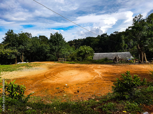 Earth place parking lot turn sand yellow brown jungle hill forest roof metall chiang mai north village outside nature
