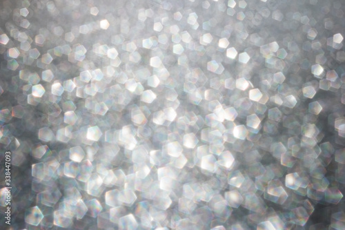 Defocused abstract colorful twinkle light background. White glittery bright shimmering background use as a design backdrop.