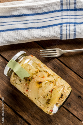 pickled aubergines on wooden table with fork photo