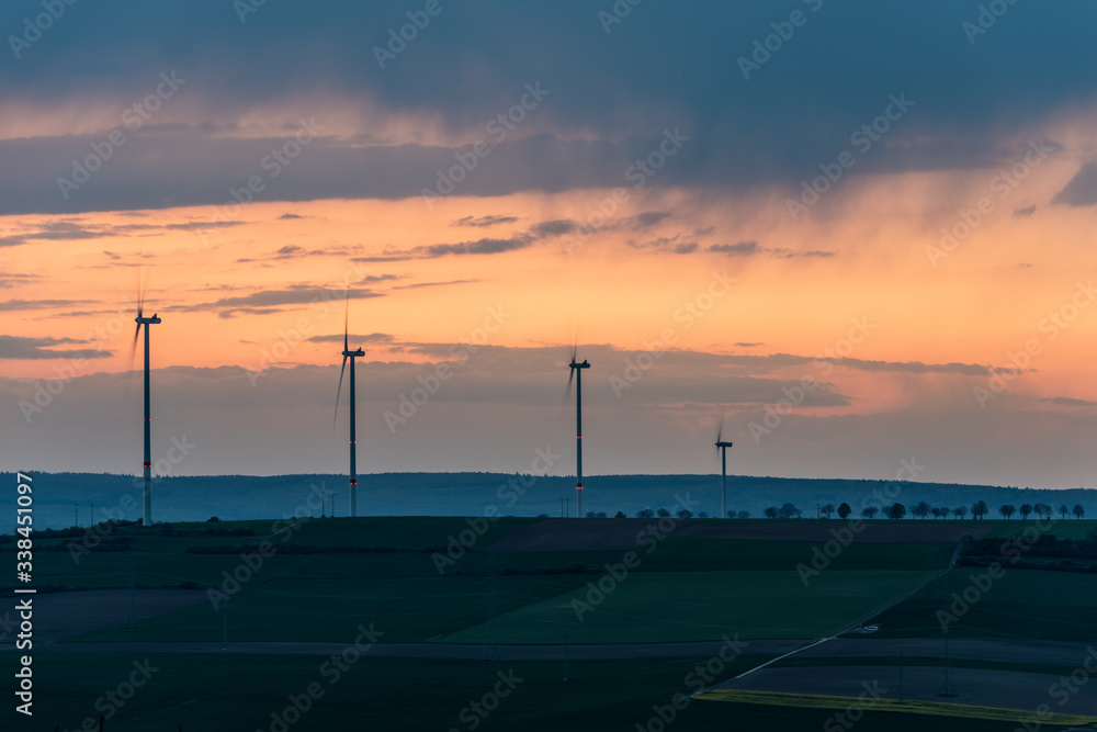 sunset over wind turbines